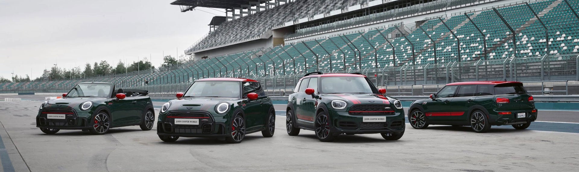 Family of four MINI John Cooper Works models parked on a race track. | Ferman MINI of Tampa Bay in Palm Harbor FL
